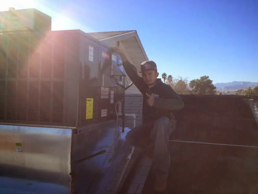 HVAC technician performing HVAC Inspection on a rooftop unit in Livermore